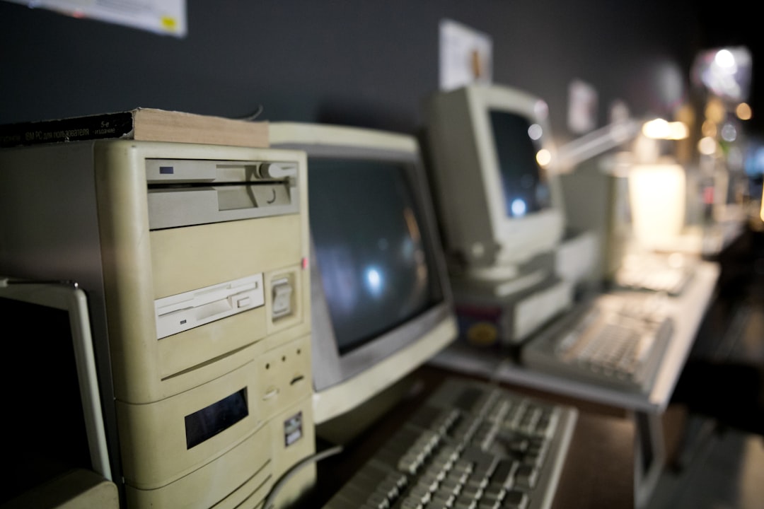 a row of old computers sitting on top of a desk
