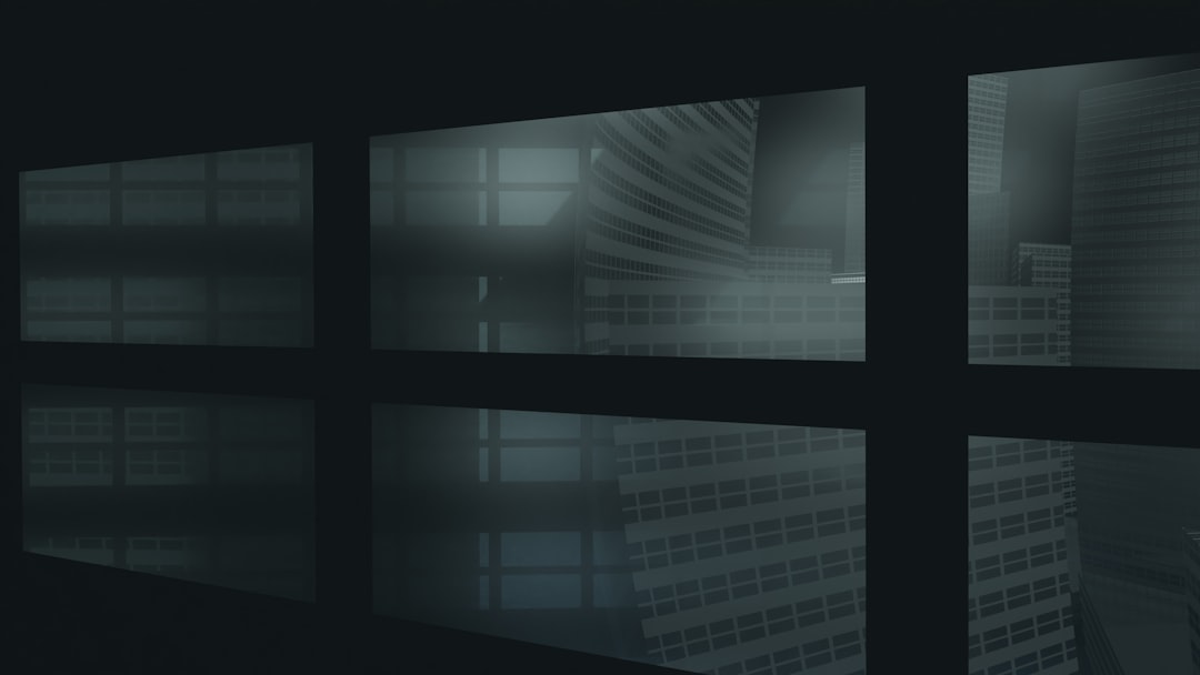 A dark room with multiple windows and a clock on the wall